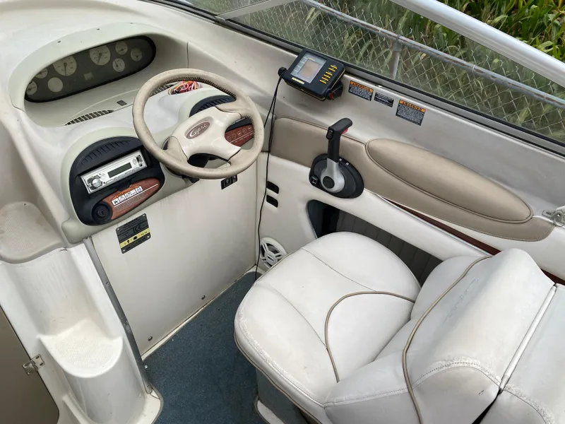 Slide: The Image of 2000 Bayliner 2352 Capri DX/LX boat interior with steering wheel and control panel. - 15