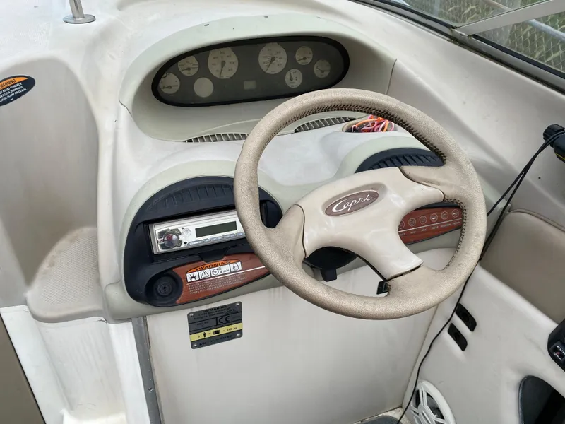 Slide: The Image of 2000 Bayliner 2352 Capri DX/LX boat dashboard with steering wheel and instrument panel. - 16