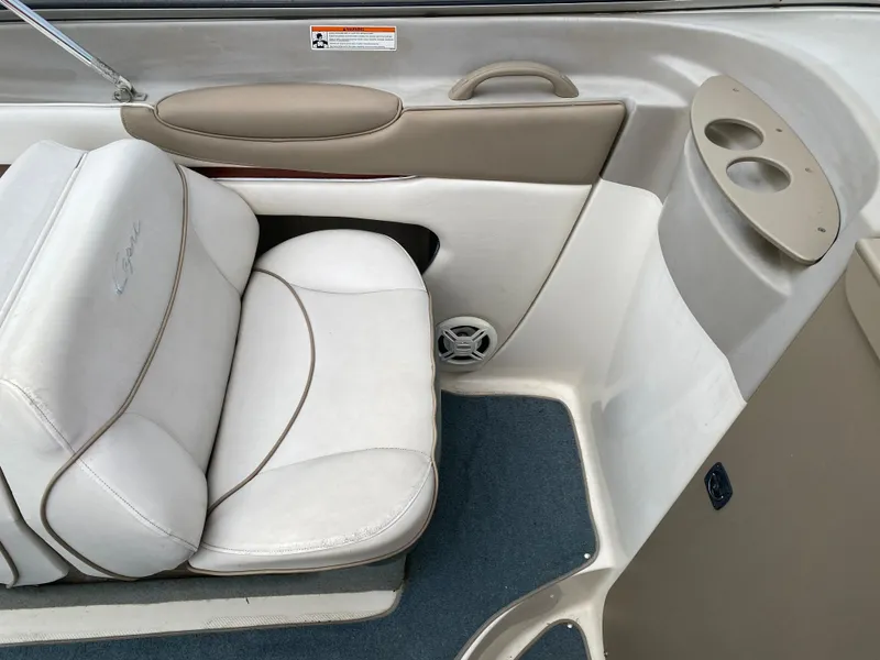 Slide: The Image of Interior of 2000 Bayliner 2352 Capri DX/LX boat with white seating and cup holders. - 18