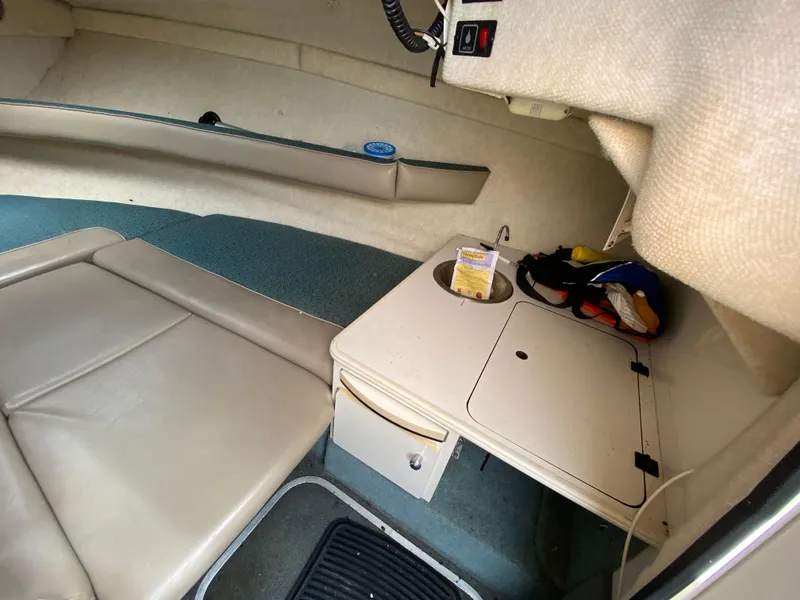 Slide: The Image of Interior of 2000 Bayliner 2352 Capri DX/LX boat with seating and storage area. - 23