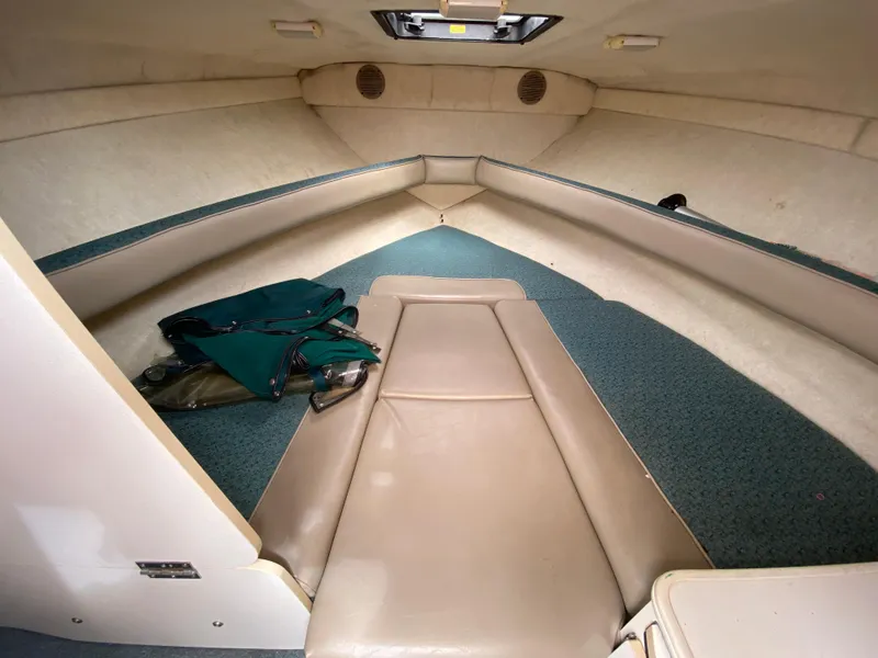 Slide: The Image of Interior cabin of 2000 Bayliner 2352 Capri DX/LX boat, featuring seating and storage. - 24