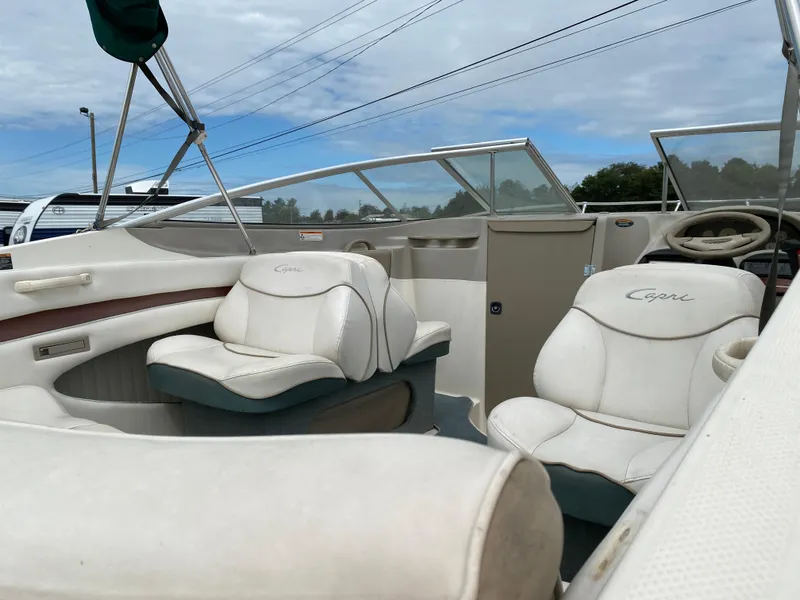Slide: The Image of 2000 Bayliner 2352 Capri DX/LX boat interior with white seating and steering wheel. - 25
