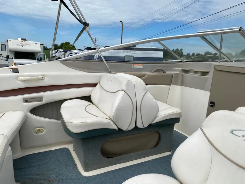 Slide: The Image of 2000 Bayliner 2352 Capri DX/LX boat interior with white seating and blue carpet. - 26