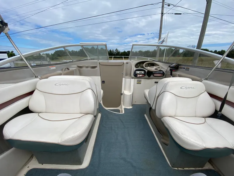 Slide: The Image of Interior of 2000 Bayliner 2352 Capri DX/LX boat with white seating and blue carpet. - 27