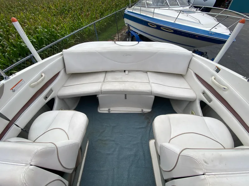 Slide: The Image of 2000 Bayliner 2352 Capri DX/LX boat interior with white seating and blue carpet. - 28