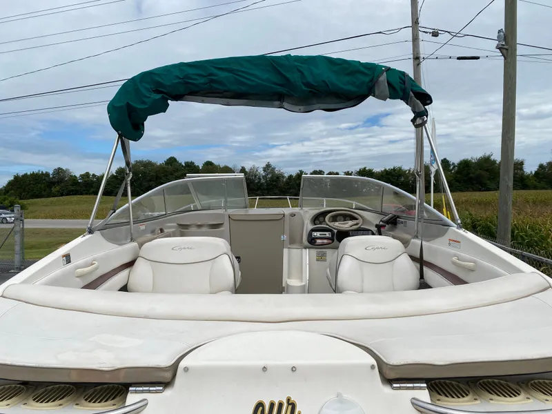 Slide: The Image of 2000 Bayliner 2352 Capri DX/LX boat with green canopy and white seating. - 30