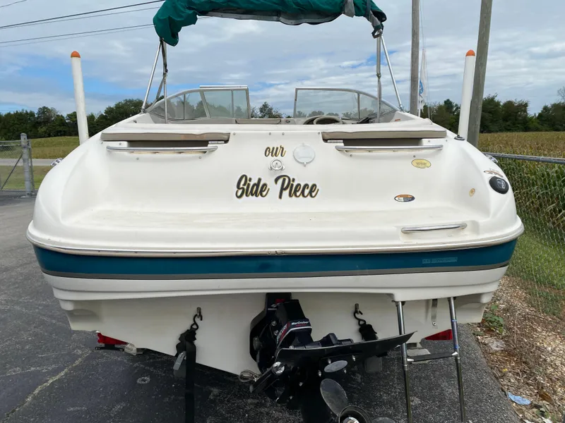 Slide: The Image of 2000 Bayliner 2352 Capri DX/LX boat with "Our Side Piece" text on the stern. - 32