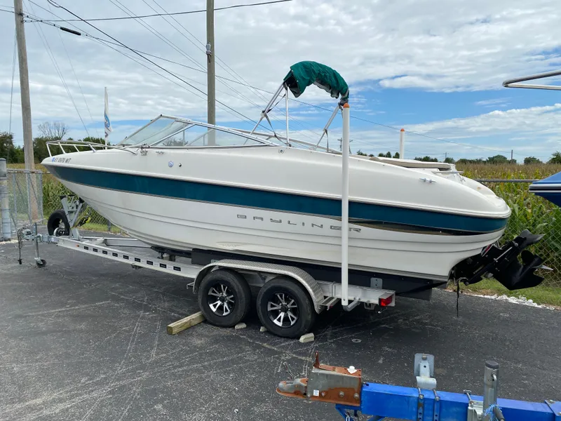 Slide: The Image of 2000 Bayliner 2352 Capri DX/LX boat on trailer, parked outdoors. - 40