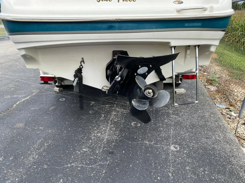 Slide: The Image of 2000 Bayliner 2352 Capri DX/LX boat rear view with propeller and ladder. - 42
