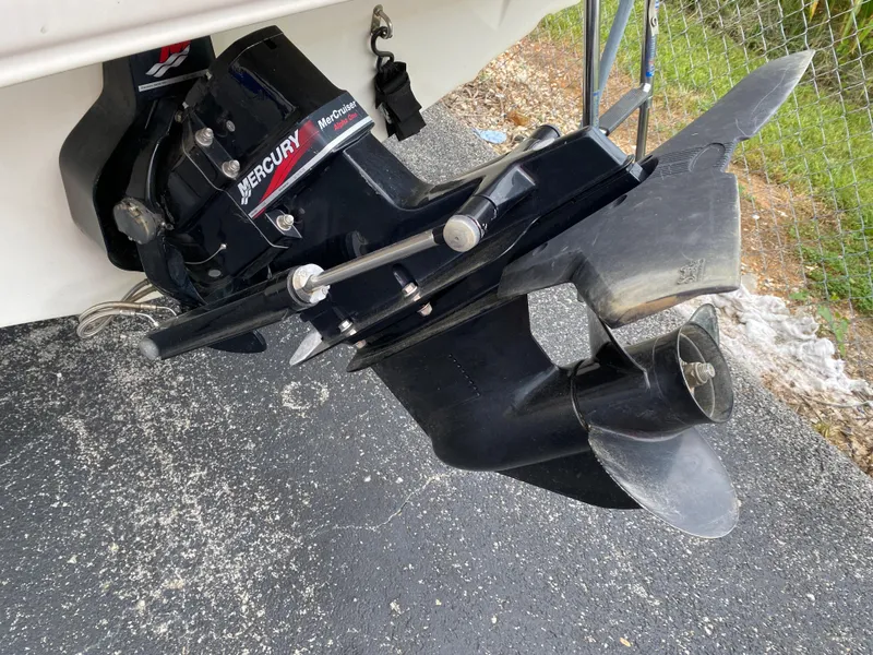 Slide: The Image of 2000 Bayliner 2352 Capri DX/LX boat with Mercury outboard motor on pavement. - 43