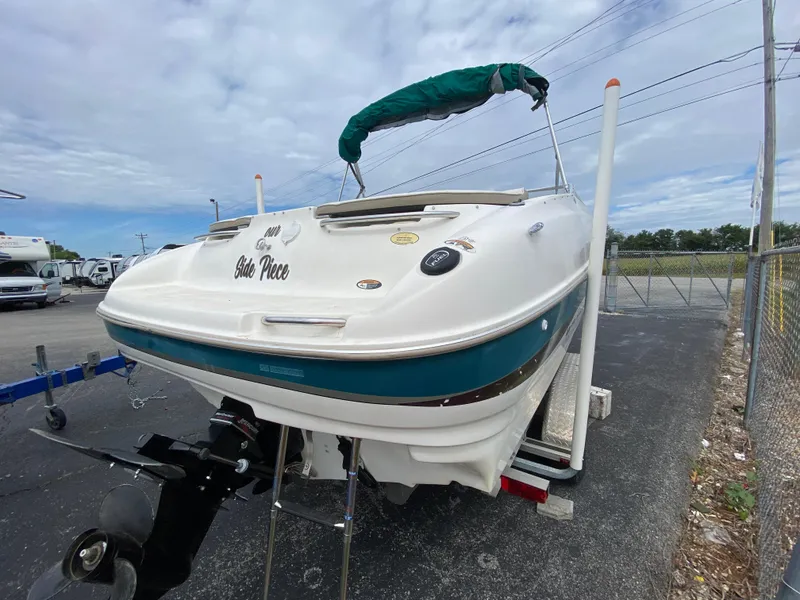 Slide: The Image of 2000 Bayliner 2352 Capri DX/LX boat on trailer, rear view, green canopy. - 45