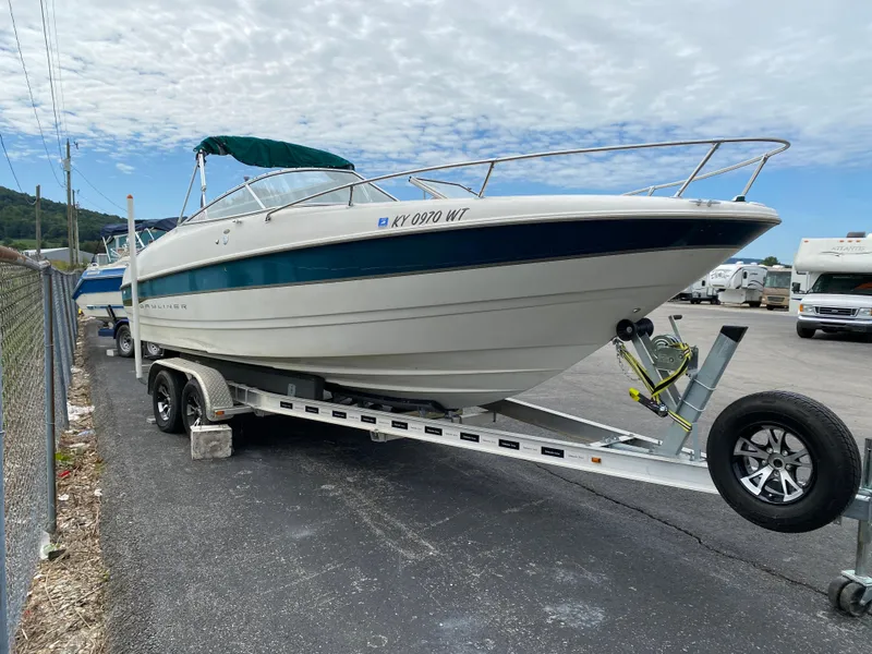Slide: The Image of 2000 Bayliner 2352 Capri DX/LX boat on trailer in parking lot. - 46