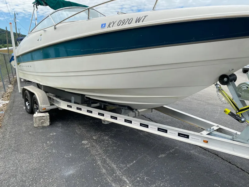 Slide: The Image of 2000 Bayliner 2352 Capri DX/LX boat on trailer, parked on asphalt. - 48