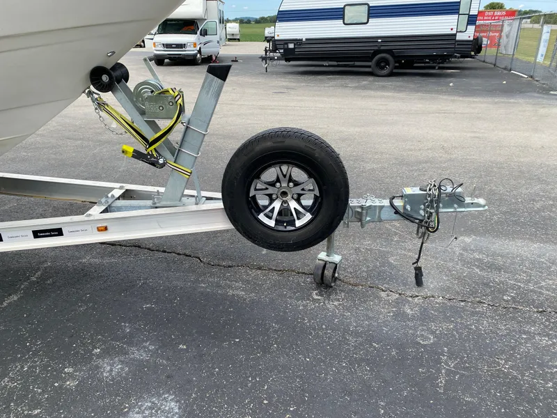 Slide: The Image of Boat trailer for 2000 Bayliner 2352 Capri DX/LX with spare tire on asphalt. - 49