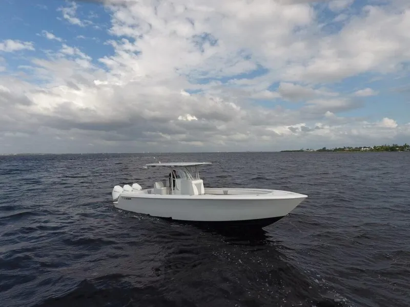 Slide: The Image of 2021 Contender 35 ST boat on open water under cloudy sky. - 1