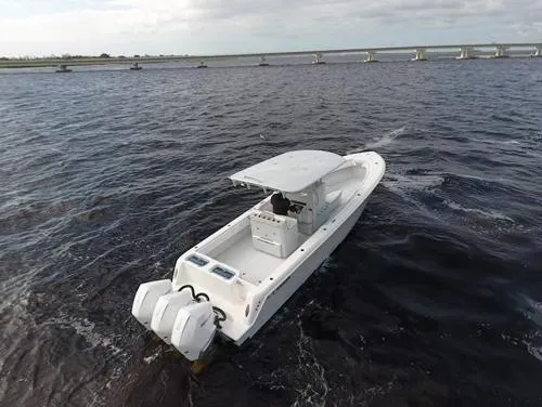Slide: The Image of 2021 Contender 35 ST boat on open water, featuring dual outboard engines. - 2