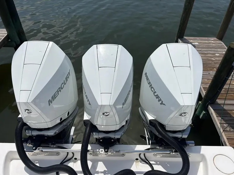 Slide: The Image of Triple Mercury outboard engines on a 2021 Contender 35 ST boat at dock. - 3