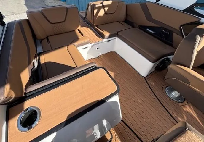 Slide: The Image of Luxurious interior of 2025 Yamaha Boats 252SD with brown seating and wood-style flooring. - 11