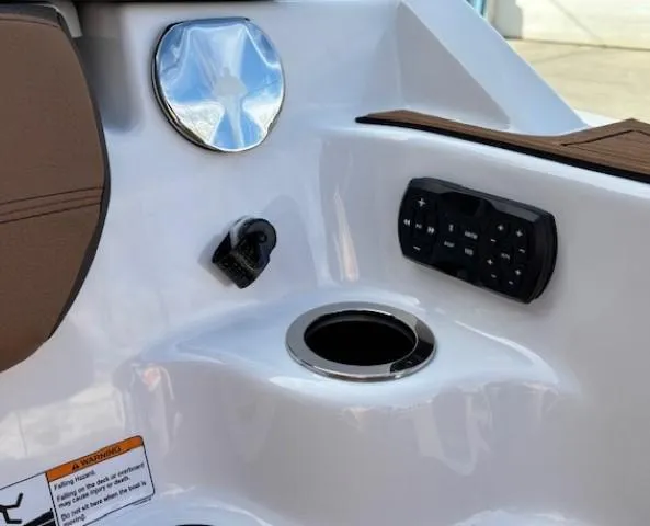Slide: The Image of 2025 Yamaha Boats 252SD interior console with cup holder and control panel. - 14