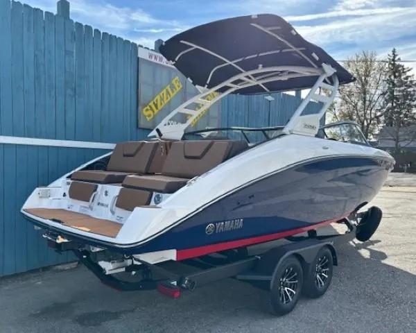 Slide: The Image of 2025 Yamaha Boats 252SD with sleek design and modern features, parked on a trailer. - 2