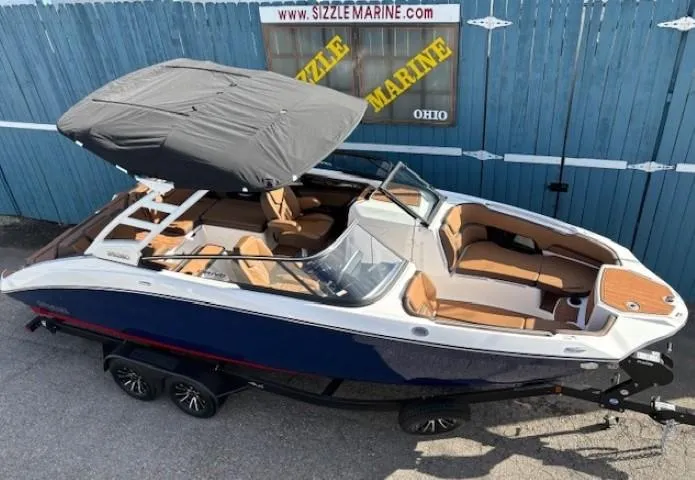 Slide: The Image of 2025 Yamaha Boats 252SD with canopy, blue and white exterior, on trailer at Sizzle Marine. - 5