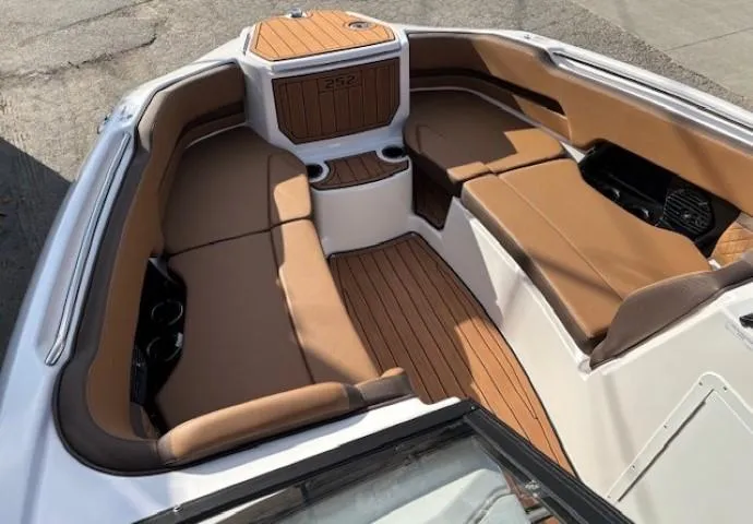 Slide: The Image of Luxurious interior of 2025 Yamaha Boats 252SD with tan seating and wood accents. - 7