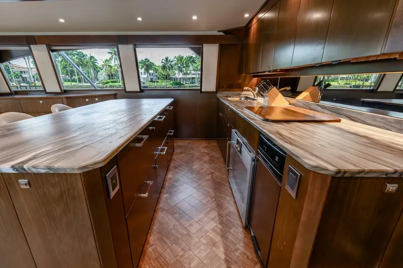 Slide: The Image of Luxurious kitchen interior of 2015 Viking 76 Convertible yacht with wooden cabinetry and modern appliances. - 13