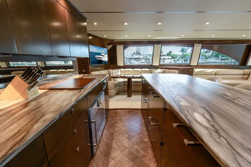 Slide: The Image of Luxurious interior of 2015 Viking 76 Convertible yacht with modern kitchen and seating area. - 14