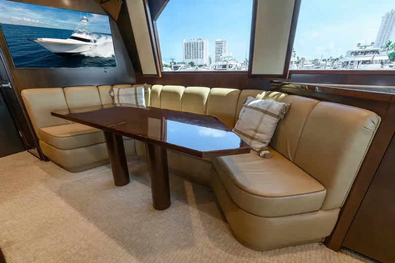 Slide: The Image of Luxurious interior of 2015 Viking 76 Convertible yacht with plush seating and elegant table. - 15