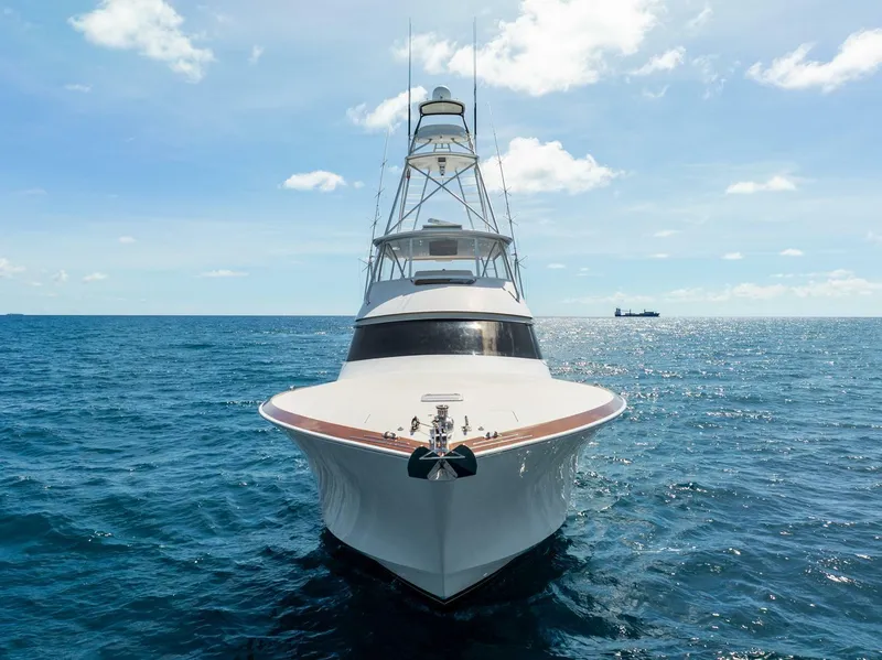 Slide: The Image of 2015 Viking 76 Convertible yacht on open sea under clear sky. - 2