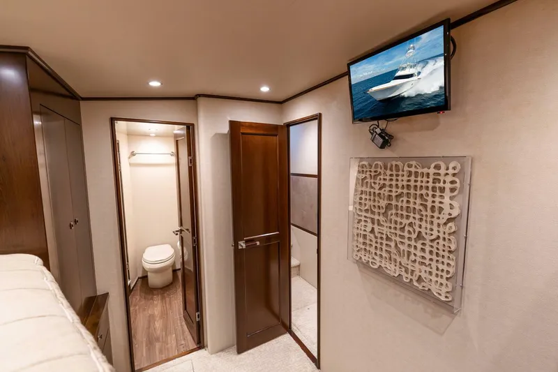 Slide: The Image of Interior of 2015 Viking 76 Convertible yacht with bathroom and wall-mounted TV. - 22