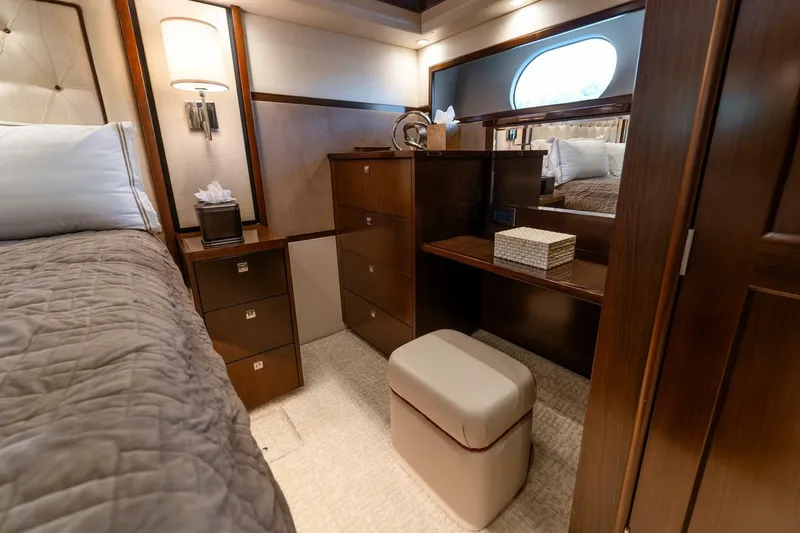 Slide: The Image of Luxurious interior of 2015 Viking 76 Convertible yacht bedroom with elegant wood furnishings. - 25