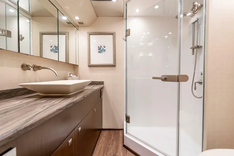 Slide: The Image of Luxurious bathroom in 2015 Viking 76 Convertible yacht with modern fixtures and glass shower. - 26