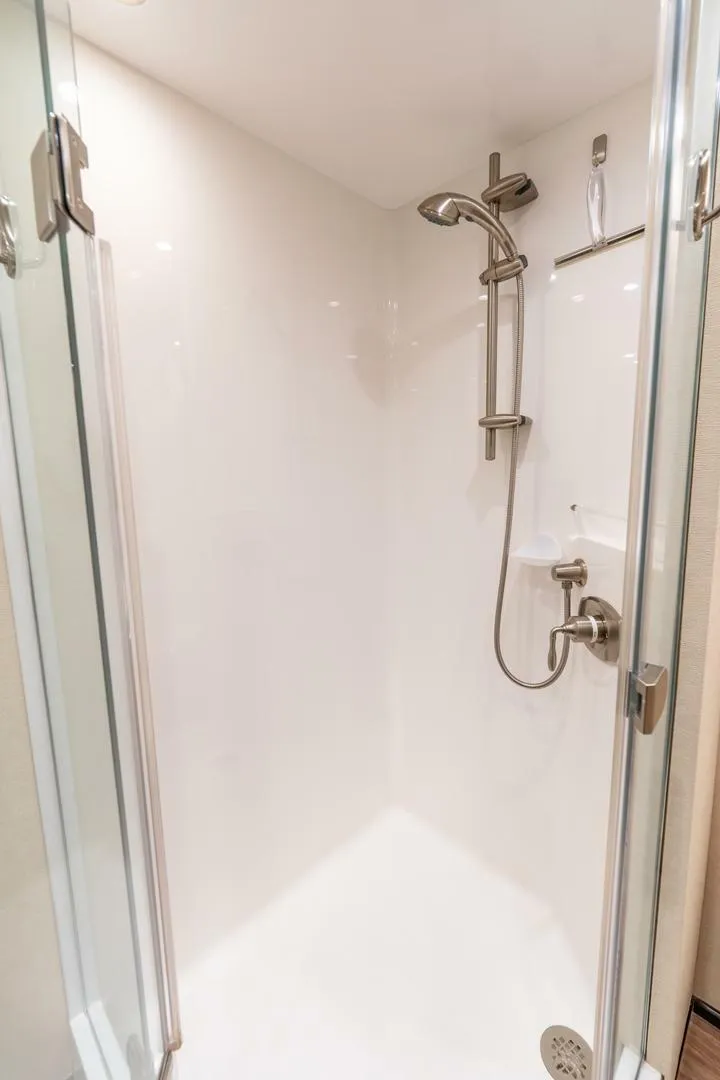 Slide: The Image of Modern shower in 2015 Viking 76 Convertible yacht with glass doors and sleek fixtures. - 27