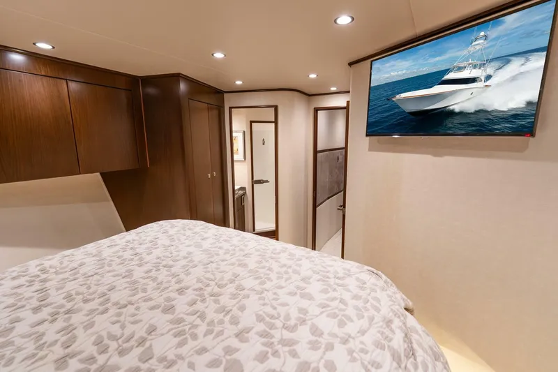 Slide: The Image of Luxurious bedroom interior of 2015 Viking 76 Convertible yacht with TV and elegant decor. - 29