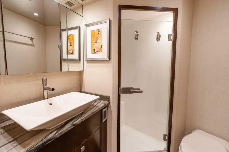 Slide: The Image of Luxurious bathroom in 2015 Viking 76 Convertible yacht with modern sink and shower. - 30