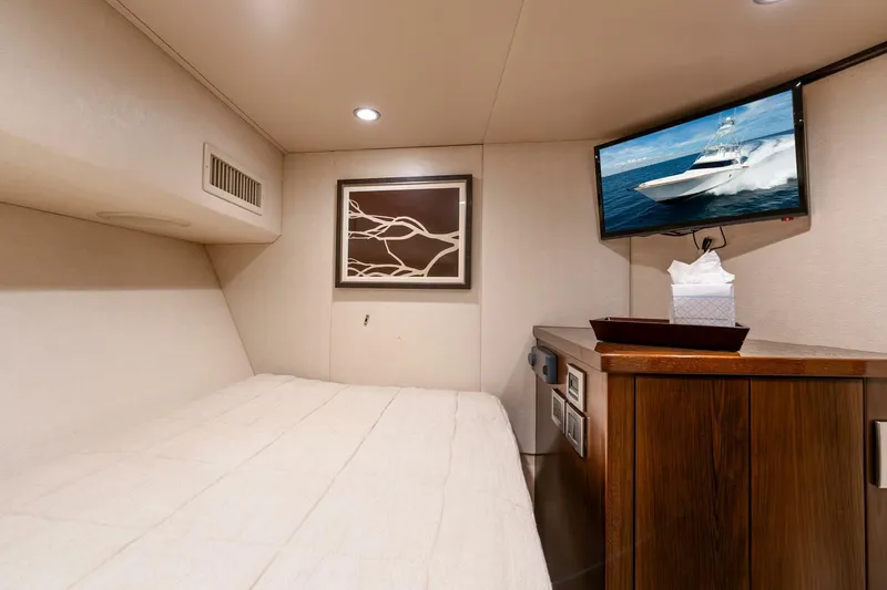 Slide: The Image of Cozy cabin interior of 2015 Viking 76 Convertible yacht with TV and artwork. - 33