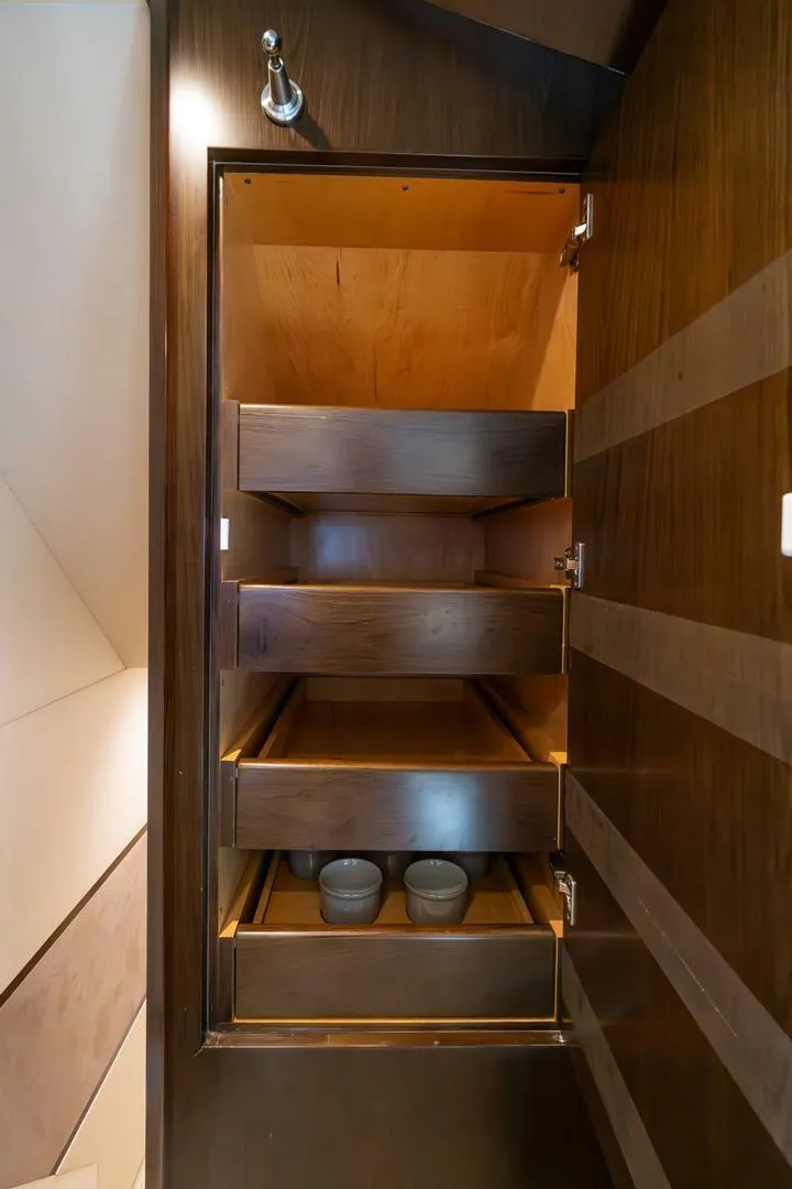 Slide: The Image of Wooden storage cabinet with open shelves on a 2015 Viking 76 Convertible yacht. - 41