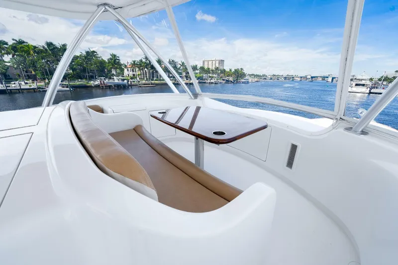 Slide: The Image of Luxurious seating area on 2015 Viking 76 Convertible yacht with scenic waterfront view. - 45
