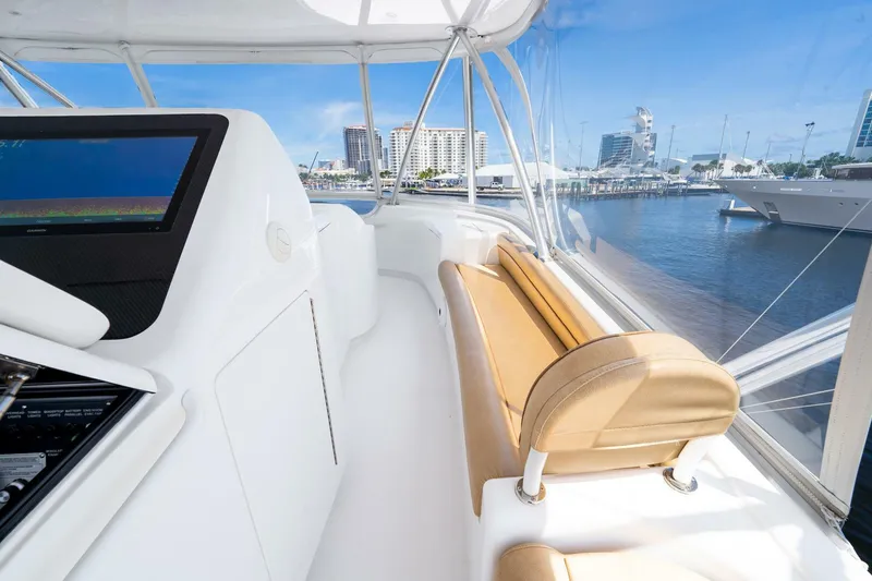 Slide: The Image of Interior view of 2015 Viking 76 Convertible yacht with cityscape in background. - 46