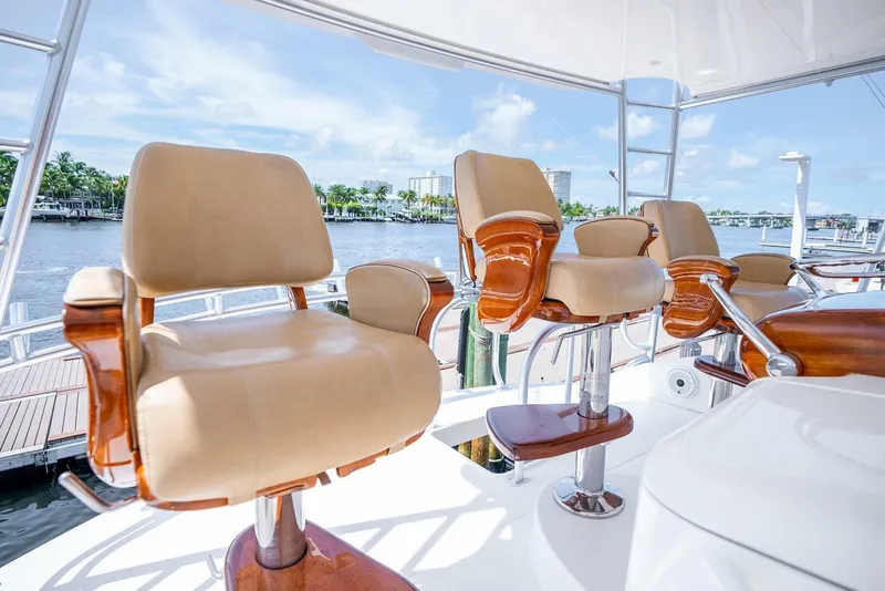 Slide: The Image of Luxurious seating on 2015 Viking 76 Convertible yacht, overlooking serene waterfront. - 49