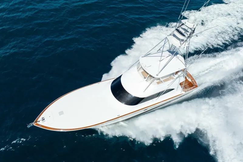 Slide: The Image of 2015 Viking 76 Convertible yacht cruising on open ocean waters. - 7