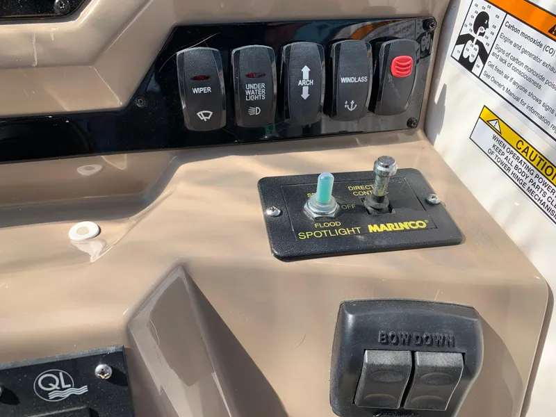 Slide: The Image of Control panel of a 2018 Regal 28 Express boat with various switches and buttons. - 16