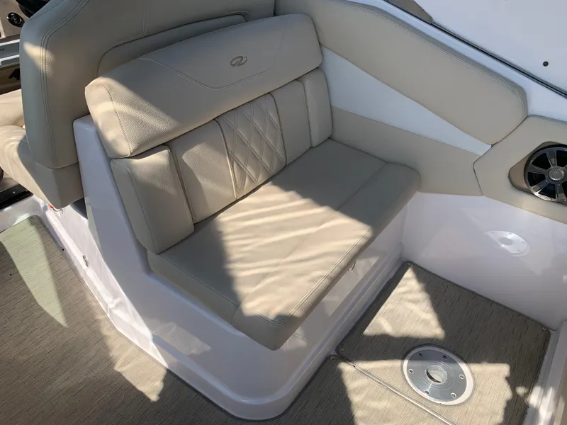 Slide: The Image of 2018 Regal 28 Express boat interior with beige seating and speaker. - 19