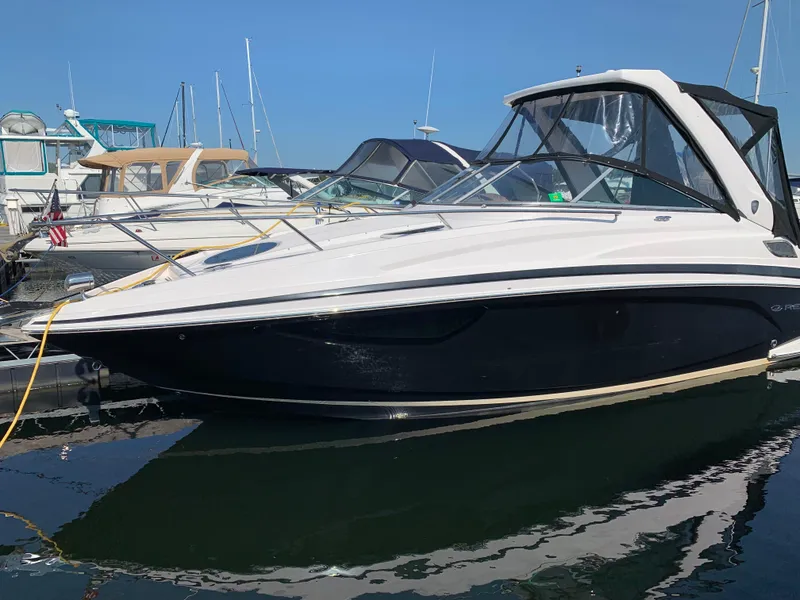 Slide: The Image of 2018 Regal 28 Express boat docked in marina, side view. - 2