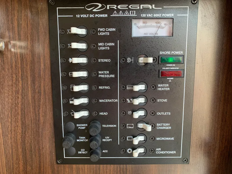 Slide: The Image of Control panel of a 2018 Regal 28 Express boat with various switches and indicators. - 26