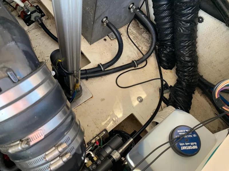 Slide: The Image of Engine compartment of a 2018 Regal 28 Express boat, showing hoses and components. - 31