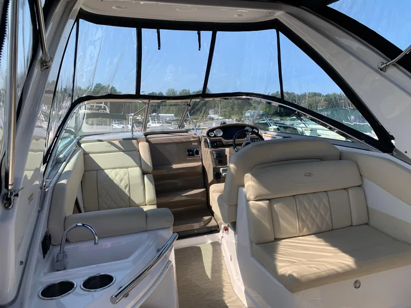 Slide: The Image of 2018 Regal 28 Express boat interior with beige seating and steering console. - 8
