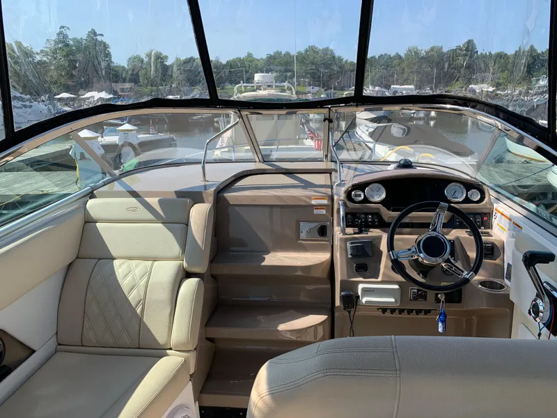 Slide: The Image of 2018 Regal 28 Express boat interior with steering wheel and seating. - 9