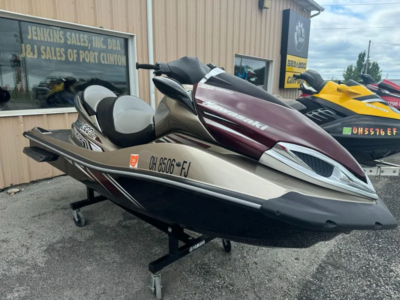 Slide: The Image of 2011 Kawasaki Ultra 310LX jet ski displayed at dealership. - 1